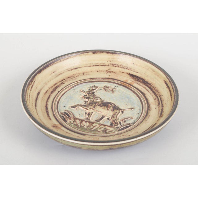 Knud Kyhn for Royal Copenhagen, stoneware dish. Round stoneware dish, model 21212, decorated in relief with an elephant...