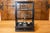 This 20th-century French scale encased in glass is a functional and decorative piece that reflects a blend of...