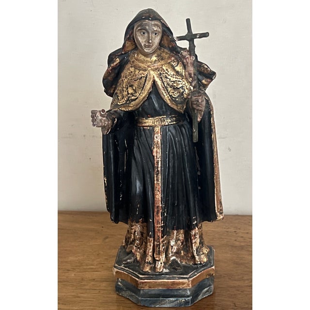 18th century Portuguese hand carved and painted wooden devotional sculpture of Saint Rita of Cascia. She is wearing a...