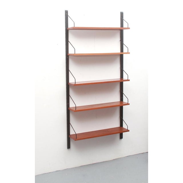 1960s shelving system made in Denmark. Design by Poul Cadovius. Teak wood construction. Includes 5 shelves. Good condition...