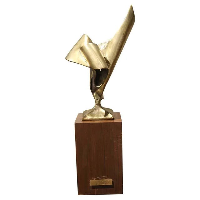 Abstract bronze ribbon sculpture created by William Robert Stevenson. The sculpture includes a beautiful wooden base that...