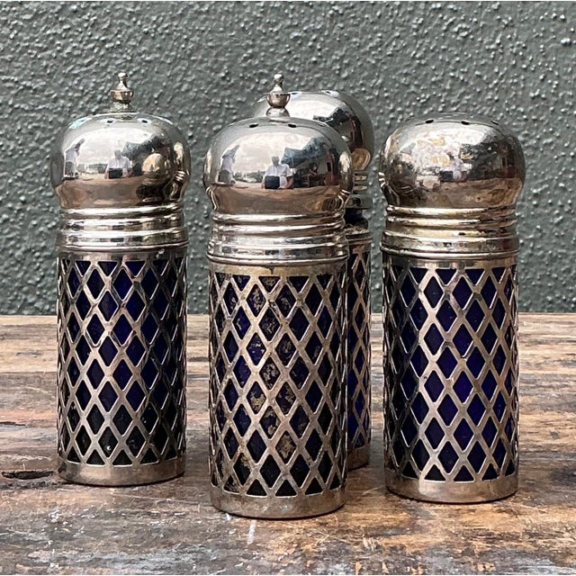 Elevate your dining experience with this curated set of twelve vintage salt shakers, featuring a sophisticated blend of...
