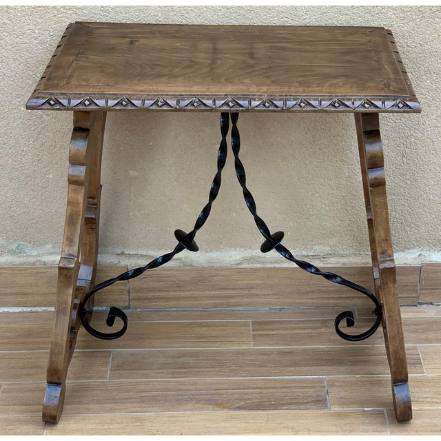 About 19th century Spanish side table with hand carved lyre leg and iron stretcher. Exquiste antique hand carved lyre-leg...