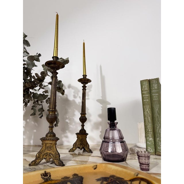 Striking pair of authentic church candlesticks, sourced by us in Rome, where our gallery is based. Crafted from cast...