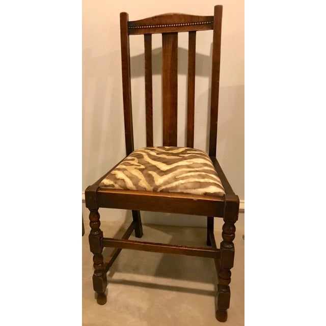 A matching pair of Jacobean early 20th Century oak chairs with turned legs, back slays and bottom stretchers. Brand new...