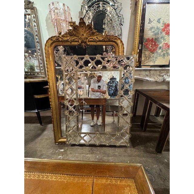 Sleek elegant Modern Murano Glass "Lattice" Mirror, finished in a tasteful light gold hue. This piece is a testament to...