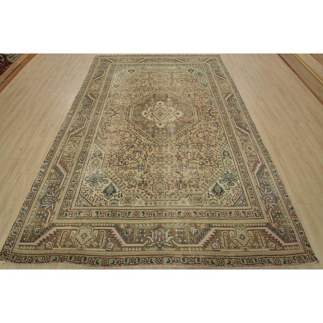 An authentic vintage traditional Tabriz rug hand-knotted with fine wool and natural dyes. This oriental rug features a...
