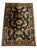 Hand-knotted area rug featuring a deep navy-blue field surrounded by a rich burgundy border. The design incorporates...