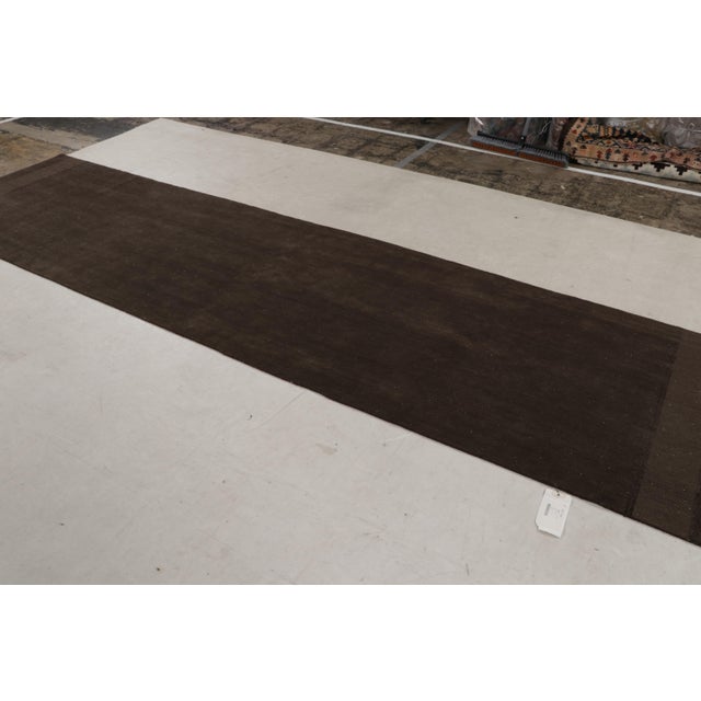 Hand-knotted in wool, this extra-long 3x18 runner rug is a new addition to Rug & Kilim’s Modern Collection, and represents...