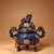 This is a finely crafted antique cloisonné enamel censer (incense burner), featuring a rounded, tripod form. The body is...