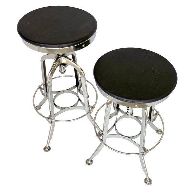 A Handsome Pair of Vintage Restoration Hardware Adjustable Stools. Made of Chrome with a Dark Wood Stained Seat. A Classic...