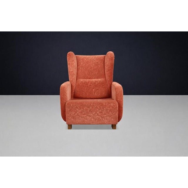 Rare Art Deco highback armchair from Prague, 1930s, featuring a sculptural wingback silhouette and original terracotta...