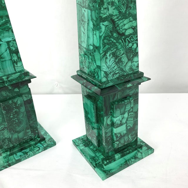 A striking pair of monumental obelisks crafted from richly figured natural malachite, showcasing the gemstone's...