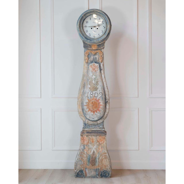 An exceptional Swedish longcase clock dated 1809, handcrafted in solid pine and retaining its original first painted...
