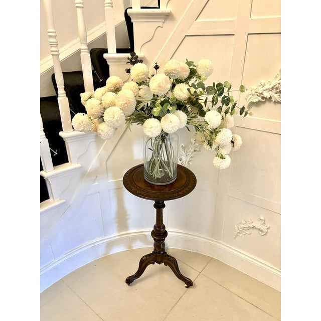 Antique Victorian quality carved burr walnut circular lamp table having a quality burr walnut circular shaped top with a...