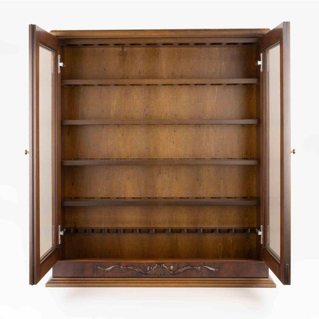Vintage pipe display cabinet, designed to elegantly showcase and protect a collection of tobacco pipes. The cabinet is...