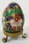 Brass scrolled foot stand presents decorated enamel Cloissone egg. Egg has vibrant colors of navy, red, green, white, and...