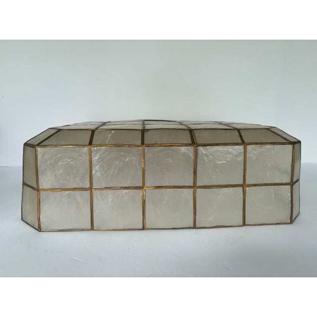 This elegant square ceiling lamp shade is handcrafted from natural Capiz shells framed in brass, featuring a geometric...