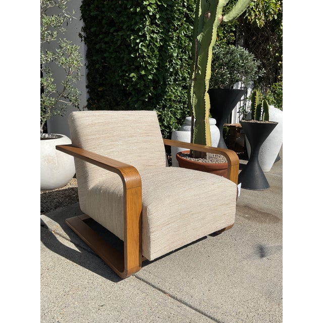 This chair is in the style of a Mid-Century chair, but is not vintage. The fabric has a mixture of neutral colors and a...