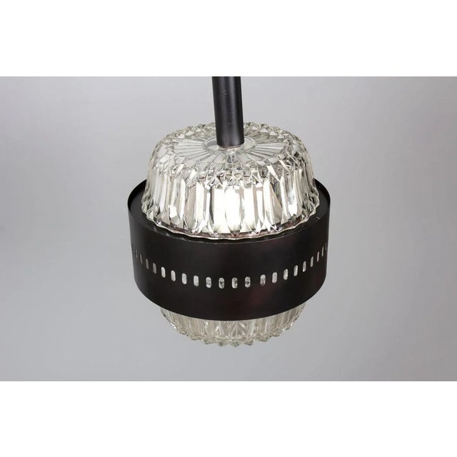 Set of 2 pendant lights from Italy in the seventies Glass globes and black lacquered metal part Nice design Up to 250V...