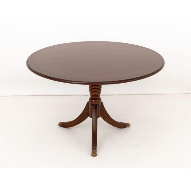 George III Style Mahogany Pedestal Dining Table, on tripod pedestal base with brass lion's paw feet. 30.5" H x 48"...