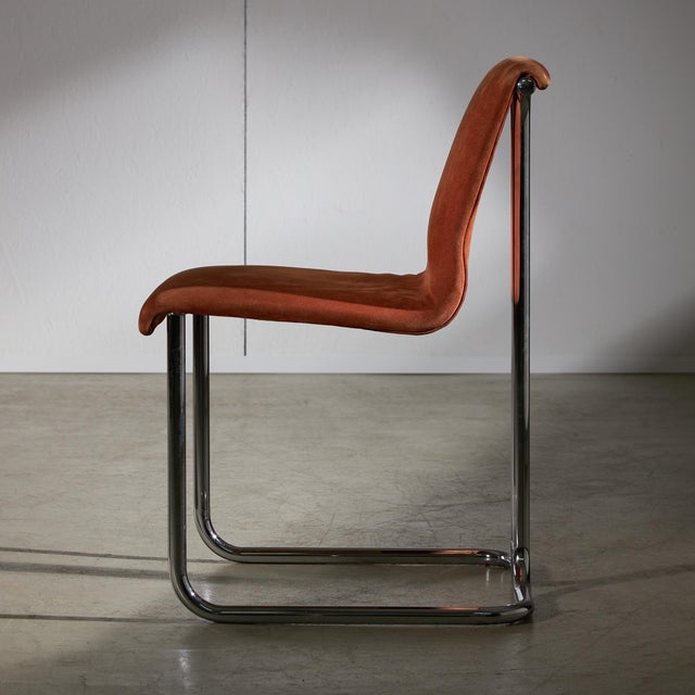 Designed with precision and attention to detail, this stunning chair is upholstered in rich, cozy orange velvet that not...