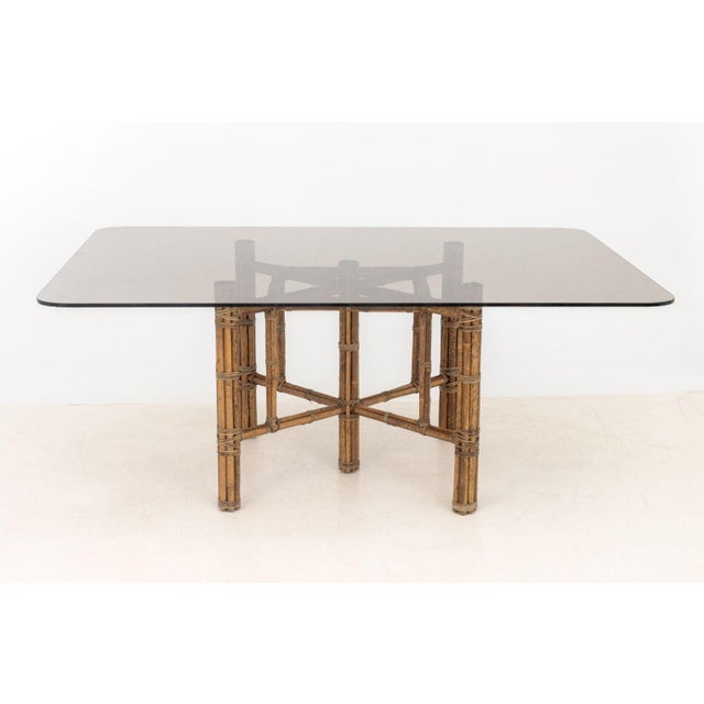 McGuire Smoky Glass and Bamboo Dining Table, the square bamboo base with rattan wrapped joints. 28.75" H x 72" W x 54" D....