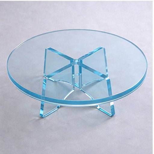 A striking sculptural round coffee table handcrafted in transparent blue lucite (acrylic). The table features a clean...
