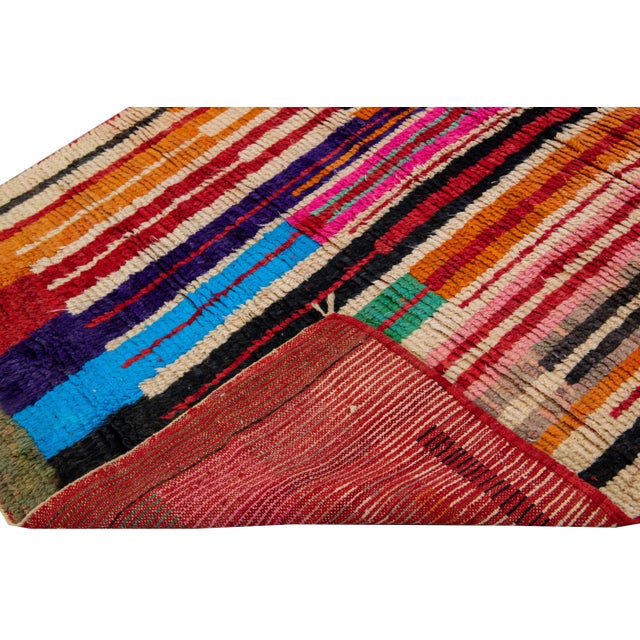 Beautiful vintage Beni Ourain Moroccan hand-knotted wool rug. This full-of-art Moroccan rug has a multi-color accents...