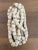 Cluster of African cow bone beads in an off white color. Beads are all tied together by a vintage rope, and would work...