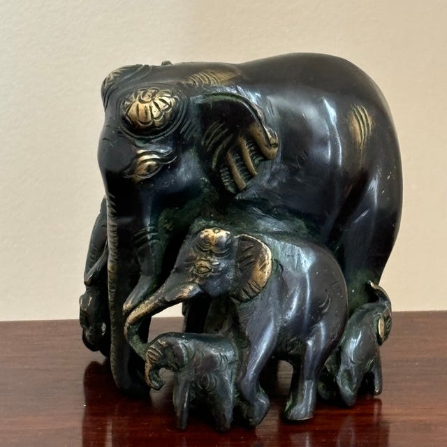Offering a stunning mid-20th century sculpted brass figure of an elephant mother surrounded by her calves. Love all of the...