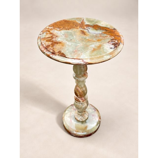 Elevate your interior with this exquisite handcrafted Onyx Marble Pedestal Table, carved from richly veined natural onyx...