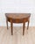 A refined early 19th century walnut half-moon game table, this elegant piece combines sophisticated design with...