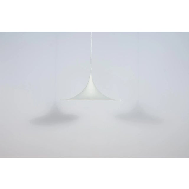 The pendant lamp semi designed by Claus Bonderup and Torsten Thorup for Fog & Morup in 1967. The Semi hanging lamp has a...
