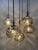 Large vintage cascade pendant lamp with 7 lights. Mouth-blown smoked glass globes with leaf reliefs. Marked with the...