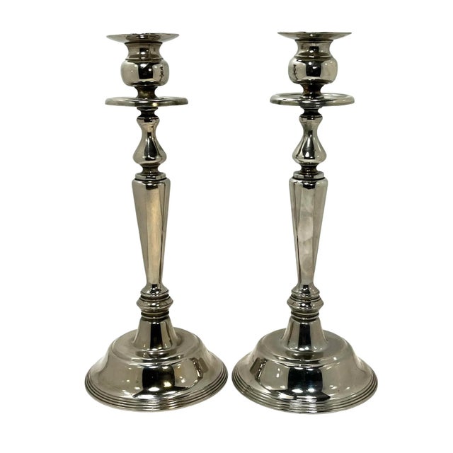Add an elegant touch to your favorite table with this fine pair of silver plate neo-classical style candlesticks by...