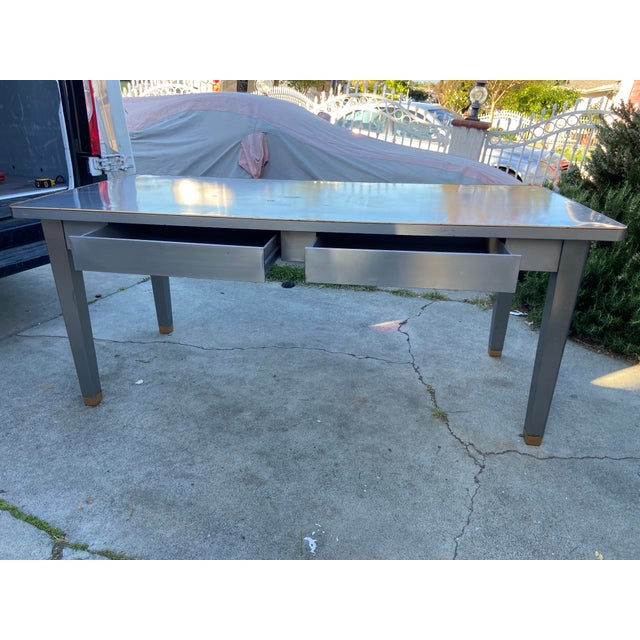 This Vintage Mid Century Modern General Fireproofing Tanker Desk Table is a rare find from the 1940's boasting a unique...