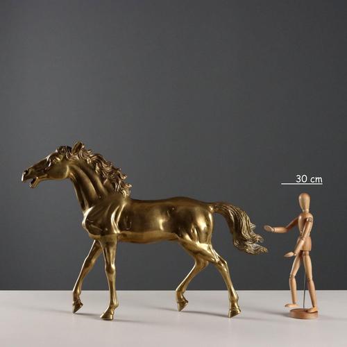 Gilded bronze sculpture depicting a trotting horse. This piece is attributed to the mentioned designer/maker. It has no...