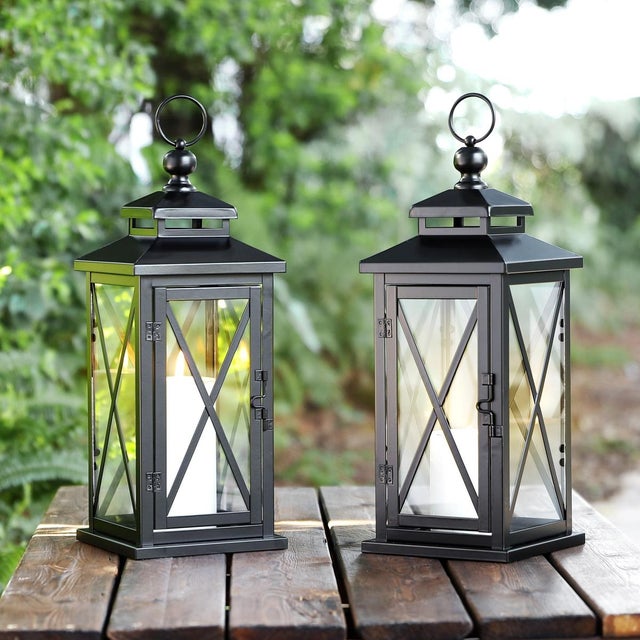 Elevate your outdoor ambiance with the Lirio Small lantern set. Standing confidently at 17.5 inches, these black iron and...