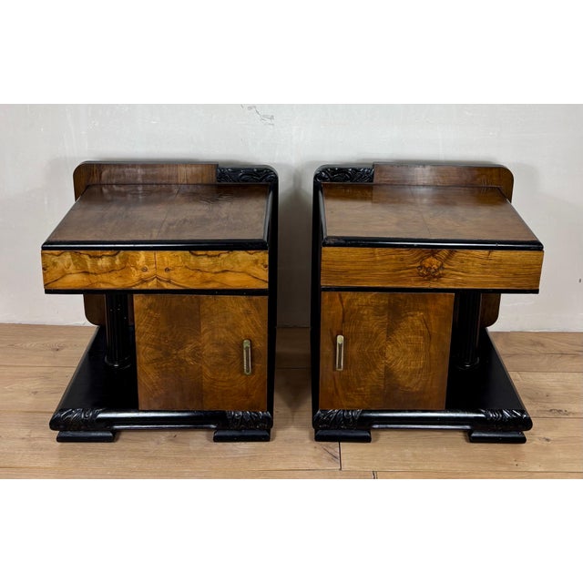 Striking pair of Art Deco nightstands featuring a bold architectural design with integrated column details and a strong...
