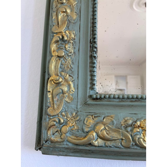 An elegant antique French Louis Philippe mirror dating from the late 19th century. This mirror features original mercury...