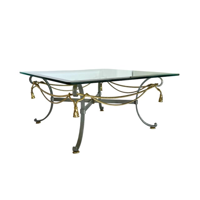An Italian 1970's Maison Jansen style mixed metal coffee table featuring a satin finish steel frame accented with brass...