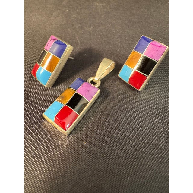 This jewelry set is a pair of sterling silver channel inlay earrings featuring a mosaic of multiple colored stones. This...