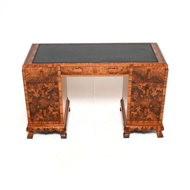An outstanding Art Deco burr walnut leather top desk. This was made in England, it dates from the 1930’s. It is of amazing...