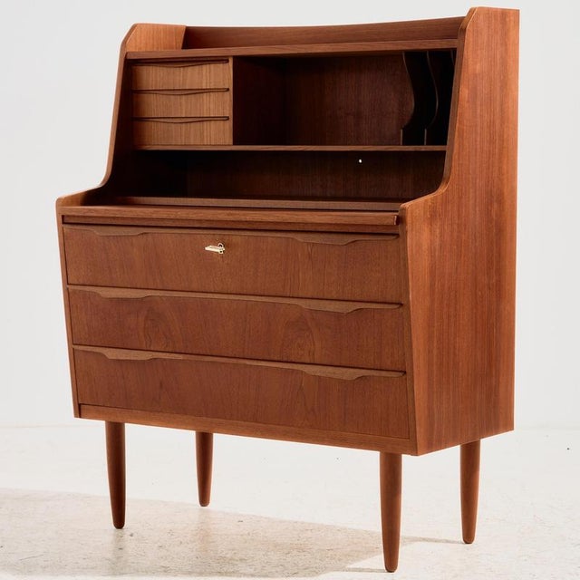 Danish teak bureau desk in restored condition with six drawers and extendable writing board from the 1960s. The furniture...