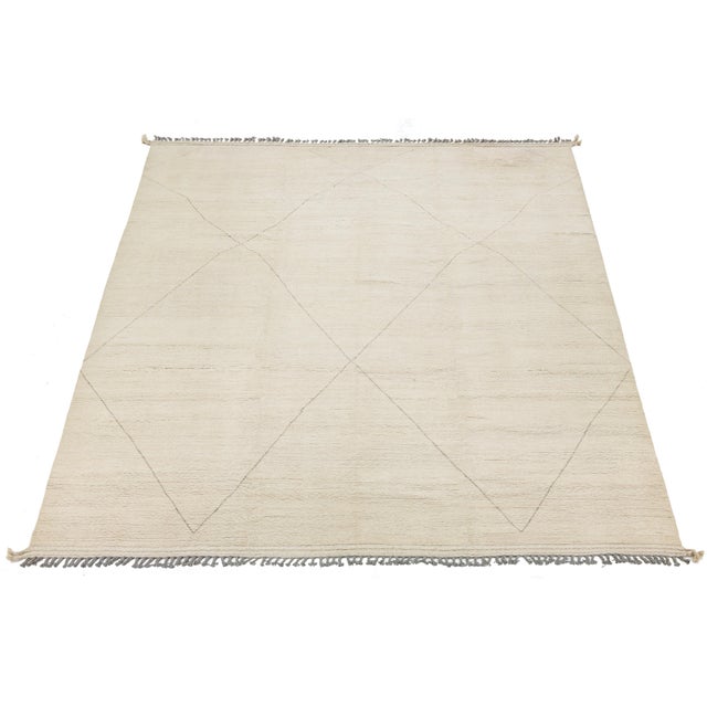 This sophisticated area rug blends timeless Moroccan tribal aesthetics with a clean, contemporary color palette. Hand-...