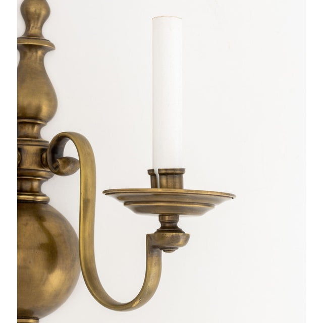 Pair of Dutch Style Bronze Two-Branch Wall Sconces, with orb-form backing plate. 14.75" H x 11" W x 7.5" D. Provenance:...