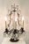 A finely composed pair of crystal girandole table lamps, distinguished by their sculptural bronze-tone frameworks and...
