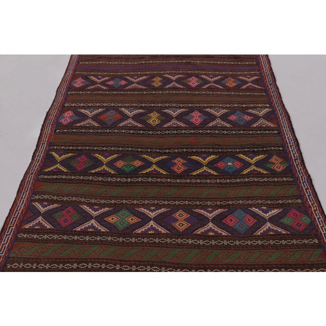 Made with handwoven wool circa 1950-1960, this 5x7 vintage Persian Kilim, originating from the Larkhabi region of...