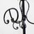Black wrought iron floor coat rack featuring elegant scrolls.